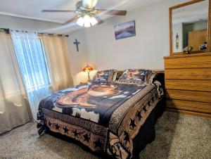 a bedroom with a large bed and a dresser at By State Fair 5 bedrooms 2 baths in Des Moines
