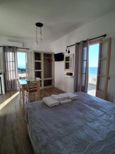 a bedroom with a large bed with a table and chairs at Blue Bliss in Ambrami