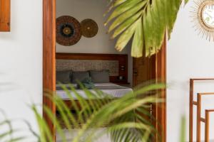 a mirror reflection of a bed in a bedroom at ISOLA - Surf House in Ahangama