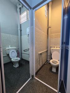 a bathroom with two toilets and a sink at Wayton Cottage in George Town +42 photos