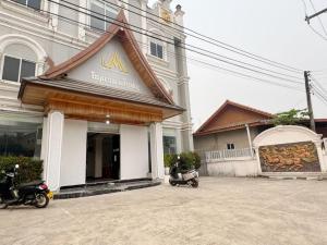 a restaurant with motorcycles parked outside of a building at Meesokxay Hotel Vang Vieng in Vang Vieng