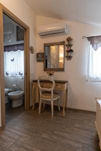 a bathroom with a table and a toilet and a sink at Grotta dei Puntali B&B in Carini +224 photos