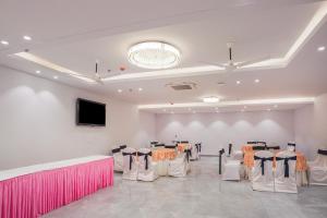 a banquet hall with chairs and tables in a room at Treebo Premium Indus Crown in Noida +35 photos