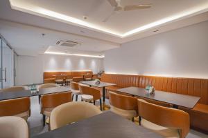 a dining room with tables and chairs at Treebo Premium Indus Crown in Noida