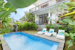 an image of a swimming pool in front of a house at Casa Lumina Canggu in Canggu