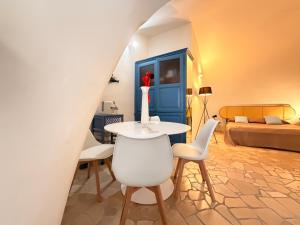 a room with a table and chairs and a bed at Suite Del Borgo in Gallipoli