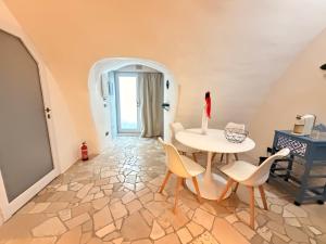 a living room with a table and chairs and a door at Suite Del Borgo in Gallipoli