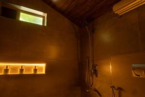 a bathroom with a shower and a window at Vanantara Riverside Eco Retreat in Cochin