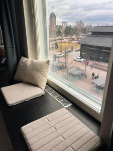 a window with a pillow and a view of a city at Top location in Joensuu in Joensuu