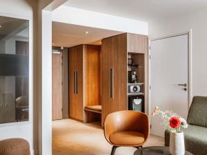 a living room with a couch and a chair at Novotel Lyon Centre-Confluence Bord de Saone in Lyon +111 photos
