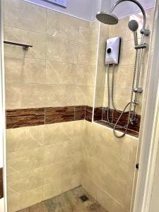 a shower with a shower head in a bathroom at Spacious 1br White House in Ban Nok +10 photos