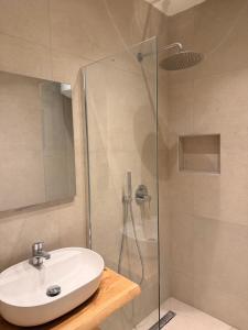 a bathroom with a sink and a shower at Thea Studios in Kassiopi +68 photos