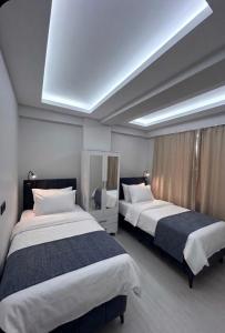 two beds in a hotel room with a skylight at Velora Suit Hotel in Nevşehir
