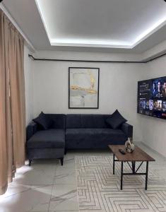 a living room with a blue couch and a table at Velora Suit Hotel in Nevşehir