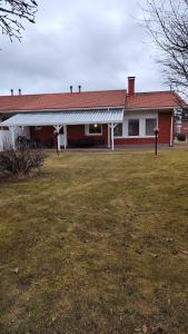 a house with a grass yard in front of it at kelankaari in Kankaanpää