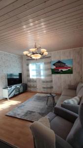 a living room with a couch and a television at kelankaari in Kankaanpää
