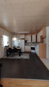 a kitchen with a table and a dining room at kelankaari in Kankaanpää