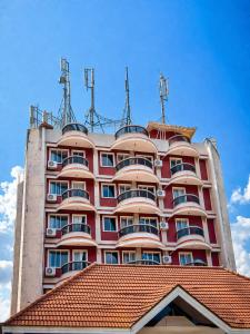 a tall red building with a red roof at Skylora Heights Inn in Kozhikode +37 photos