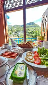 a table with plates of food on top of it at Aurora Residence Nuwara Eliya in Nuwara Eliya +67 photos