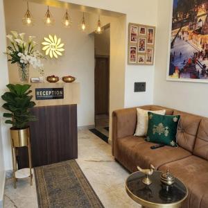 a living room with a couch and a table at Hotel RK Heritage in Varanasi
