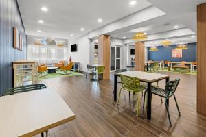 a dining room with tables and chairs in a cafeteria at Spark by Hilton Stillwater in Stillwater
