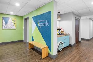 a waiting room with a bench in a spark office at Spark by Hilton Stillwater in Stillwater