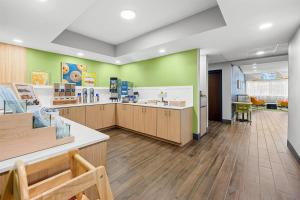 a store with green walls and wooden counters at Spark by Hilton Stillwater in Stillwater