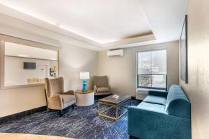 a living room with a blue couch and chairs at Comfort Inn & Suites Saint Louis Lafayette Square in Saint Louis