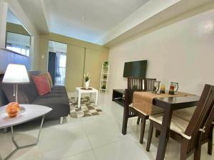 a living room with a couch and a piano at Pacific Staycation in Kaybagal