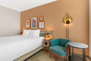 a hotel room with a bed and a chair at Cambria Hotel Euless - DFW Airport South in Euless +60 photos