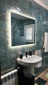 a bathroom with a sink and a mirror at Villa Òdena in Odena +13 photos