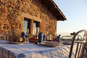 a table with plates of food on top of it at Cal Miger in Tiurana