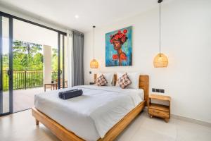a bedroom with a large bed and a balcony at Dreamland Suites - Walk to Dreamland Beach in Uluwatu