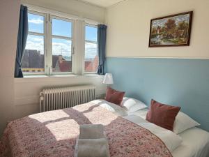 a bedroom with a bed and a window at Hotel Faaborg in Faaborg