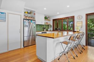 a kitchen with a counter and a refrigerator at Dragonflies on Billa in Point Lookout