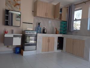 a kitchen with wooden cabinets and a stove top oven at The Elite havens in Nairobi +12 photos