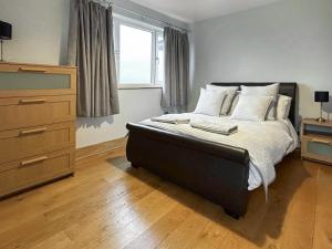 a bedroom with a bed and a dresser and a window at The Annexe - Uk51362 in Dollar