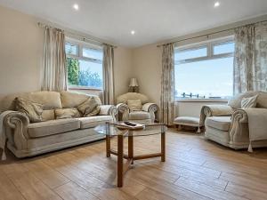 a living room with a couch and a table at The Annexe - Uk51362 in Dollar