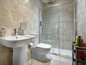 a bathroom with a toilet and a sink and a shower at The Annexe - Uk51362 in Dollar +4 photos
