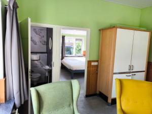 a room with a bedroom with a bed and a chair at Vakantiepark de Bronzen Eik in Sellingen