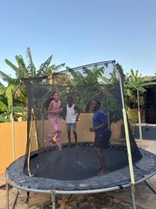 a group of people standing on a trampoline at Rainbow Palace Apartment in Sekondi-Takoradi
