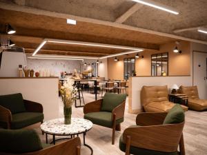 a lobby with couches and tables and a bar at Mercure Paris Bastille Marais in Paris