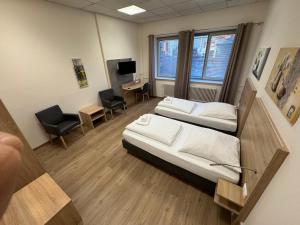 a hospital room with two beds and a desk at Boardinghaus-net in Fulda