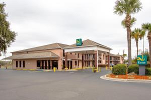 a building with a krispy kreme sign in front of it at Quality Inn & Suites Live Oak I-10 Exit 283 in Live Oak