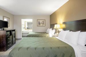 a hotel room with two beds and a television at Quality Inn & Suites Live Oak I-10 Exit 283 in Live Oak +27 photos