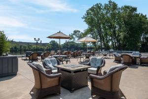 a patio with chairs and tables and umbrellas at Radisson Hotel Grand Rapids Riverfront in Grand Rapids
