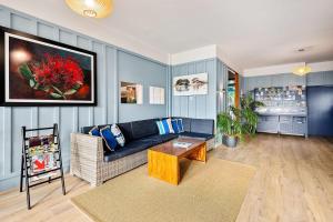 a living room with a couch and a table at Quality Hotel Oceans Tutukaka in Tutukaka