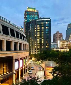a city with tall buildings and cars on a street at Shanghai Hills&Well-time MCM Family loft Near Line2 and line13 West Nanjing Road in Shanghai