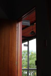 a sign that reads havana is seen through a window at Hacienda Casa de Piedra in Tlacolula de Matamoros +1 photo