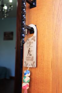 a wooden door with a sign on it with foururnedools at Hacienda Casa de Piedra in Tlacolula de Matamoros